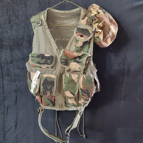 137 - A tactical, load bearing vest with numerous pockets and adjustable strap, in a camouflage finish.