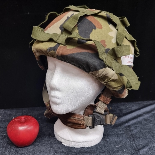 141 - An Irish army Kevlar helmet, dated September 1986. With genuine leather interior straps, and camoufl... 