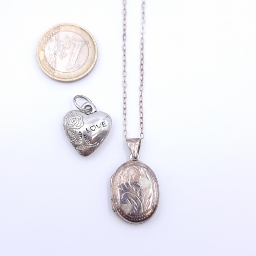 20 - A sterling silver locket with intricate scroll detailing and sterling silver chain. Together with a ... 