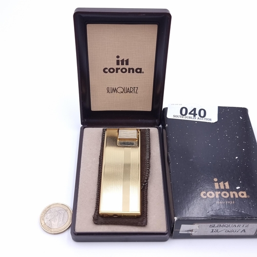 40 - A  Corona slim quartz lighter, with machine cut detailing. Comes in original box with packaging.