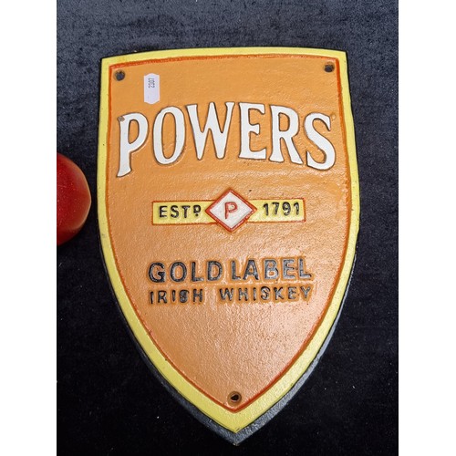 753 - A lovely heavy cast metal wall mounting plaque for Powers whiskey in a bright orange.