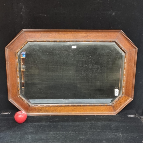 101 - A fabulous vintage octagonal bevelled wall hanging mirror with dark oak frame and dentil detail.