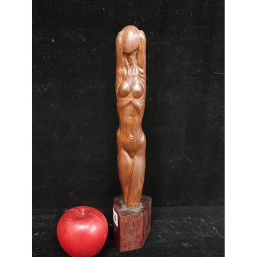 114 - An elegant hand carved wooden sculpture depicting a nude female with hands bent behind her head. Mos... 