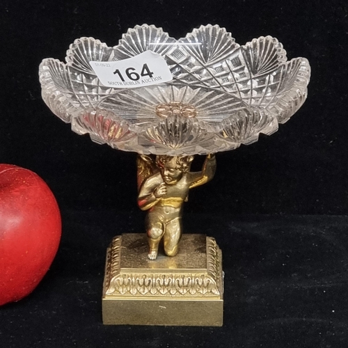 164 - A pretty bonbon dish with heavy brass figural base in the form of a cherub with scalloped crystal ba... 