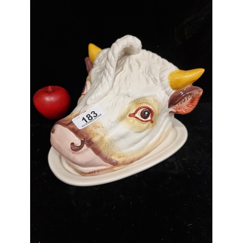 183 - A large hand-painted ceramic cheese dome in the form of a bull's head. In great condition.