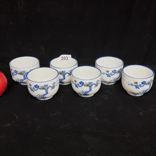 203 - An elegant set of six sake cups, illustrated with delicate cherry blossom trees.