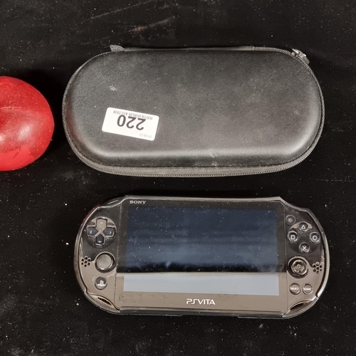 220 - A Playstation Vita handheld games console in original hard carry case.