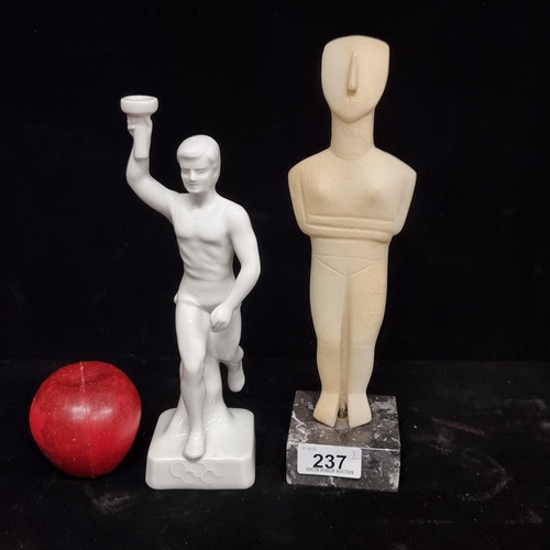 237 - Two figurines, including an original 1980 Soviet porcelain candle holder with Olympic torch barer st... 