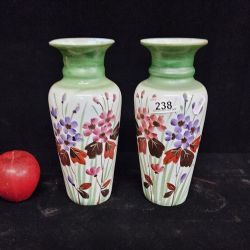 238 - A delicate pair of milk glass vases, with hand painted floral motifs and green rims. Good condition.