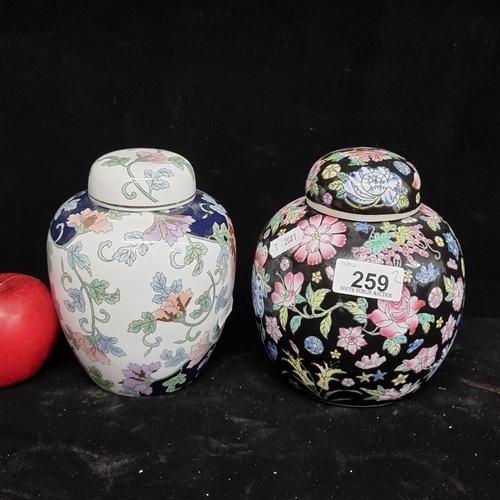 259 - Two beautiful Chinese ginger jars with magnolia and chrysanthemum motifs throughout. Stamped to base... 