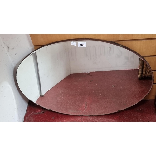 288 - A good sized vintage bevelled oval wall mirror - nice looking piece.