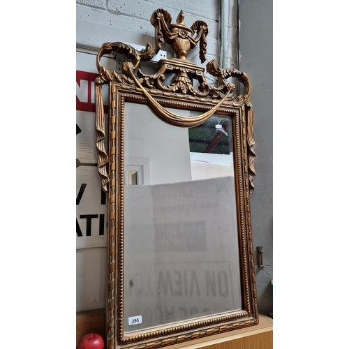 295 - A beautiful example of a Regency style bevelled mirror, with ornate urn pediment. Featuring swags an... 