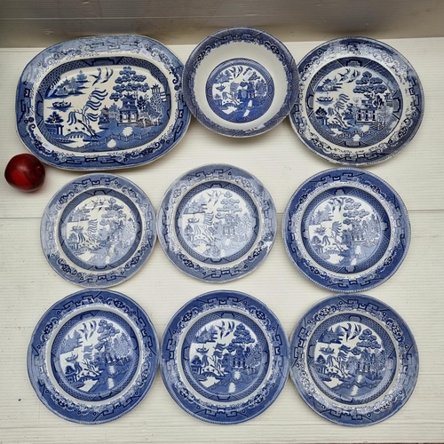 312 - A selection of nine ceramic dishes each glazed in a Willow pattern. Accompanied by a jug with a croc... 