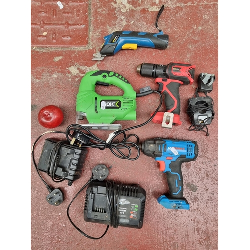 343 - A collection of 4 power tools including a Ferrex drill and a ROK jigsaw. Along with three batteries.