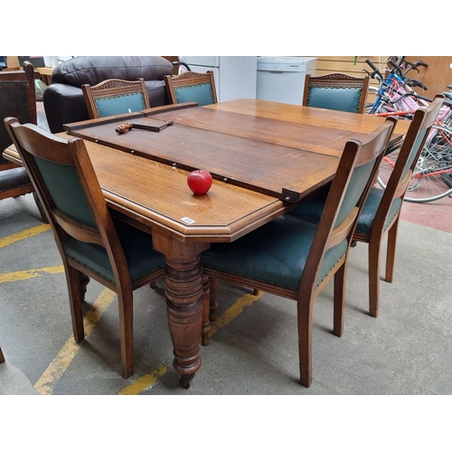 370 - Star Lot : A very large and grand antique oak dining table with 2 extendable leaves accompanied by 6... 