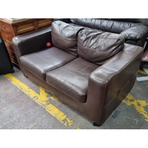 374 - A lovely neat two seater sofa with warm brown leather upholstery and saddle stitch detailing.