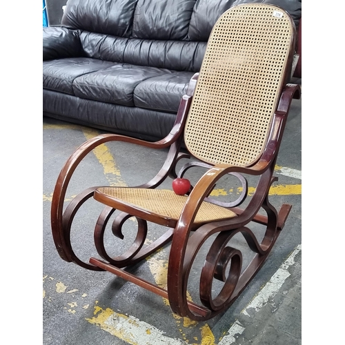 376 - A fabulous quality  bentwood rocking chair with curved bentwood design and rattan seat and back. A v... 