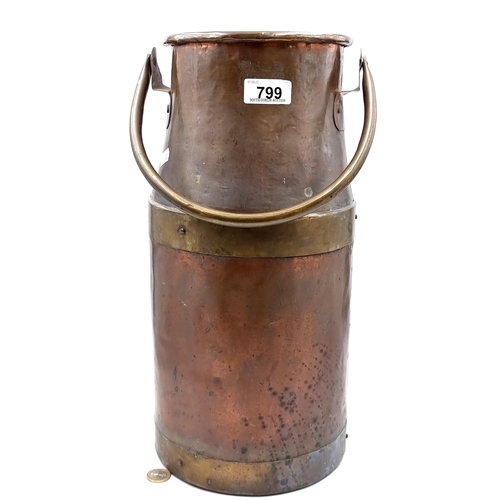 799 - A good copper and brass antique milk churn. With swing handle.