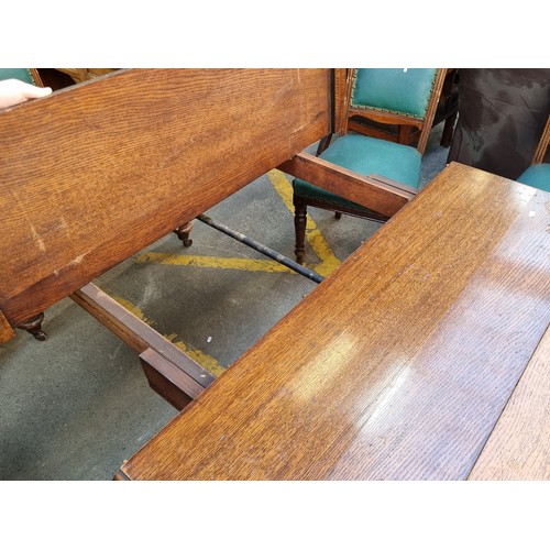 370 - Star Lot : A very large and grand antique oak dining table with 2 extendable leaves accompanied by 6... 