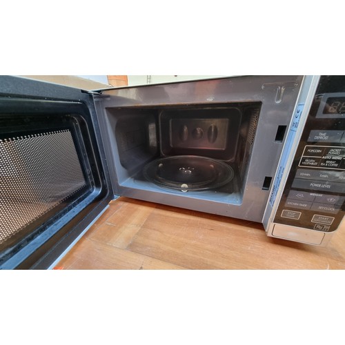 390 - A Sharp 800w digital microwave oven in silver.