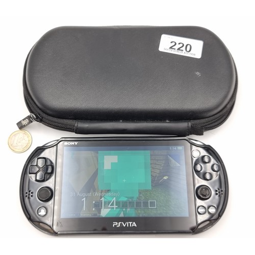 220 - A Playstation Vita handheld games console in original hard carry case.