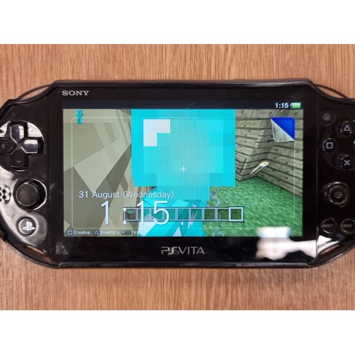 220 - A Playstation Vita handheld games console in original hard carry case.