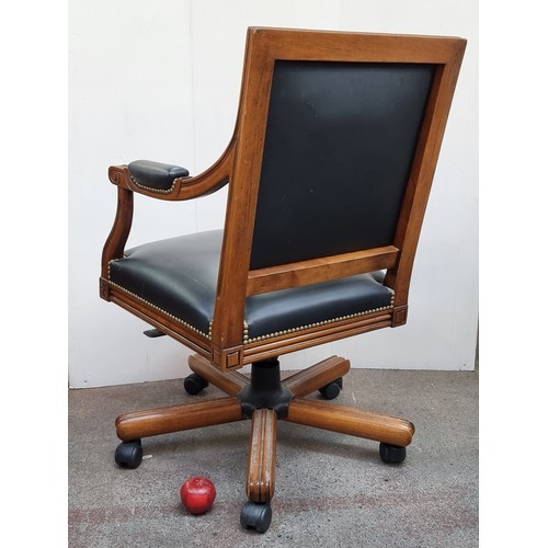 271 - A fantastic example of a captains style chair with swivel seat and large castors. Upholstered in a b... 