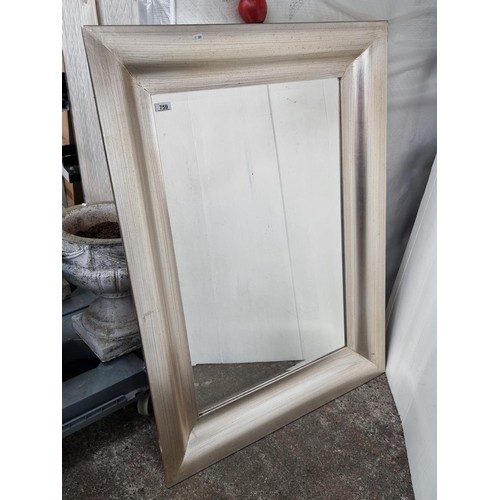 658 - A very large rectangular vertical mirror in a modern frame with silver finish. H120 cms x W88 cms. L... 