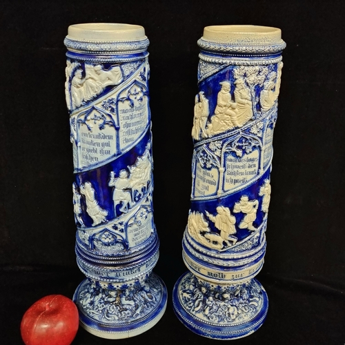 116 - A pair of tall ceramic, stoneware vases. Featuring a cobalt blue glaze and relief detail throughout.... 