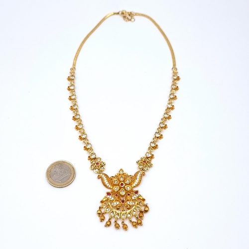 26 - A profuse Gold toned drop pendant necklace, set with an array of stunning intricate gem stones. Leng... 