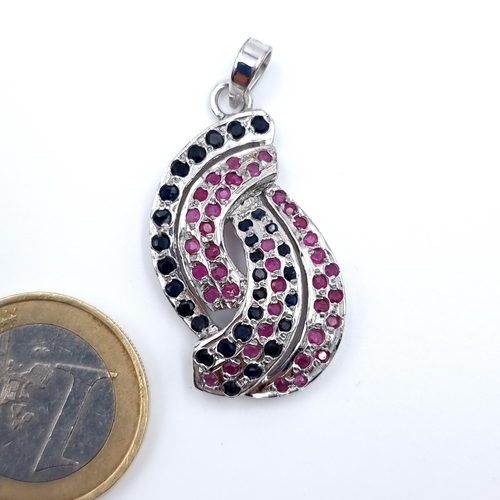 3 - A striking Ruby and Sapphire set abstract design pendant set in Sterling Silver. Total weight: 6.25 ... 