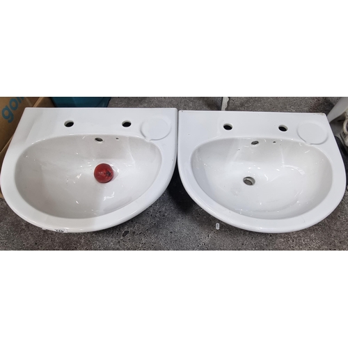 493 - A set of two new matching porcelain sinks. With an impressed soap rest. In new condition