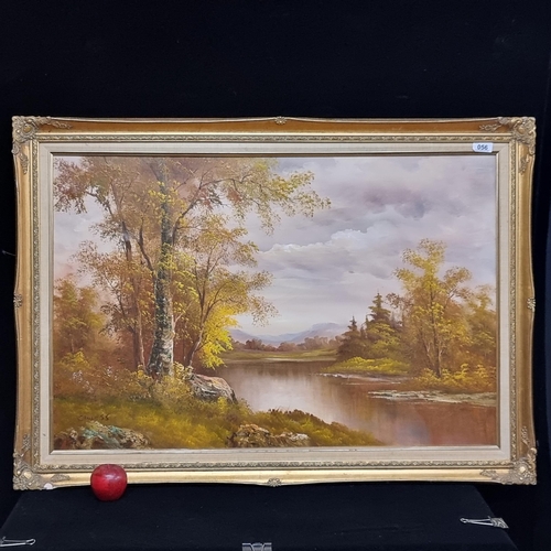 56 - A very large original oil on canvas painting of an autumnal lakeside landscape. Signed by the artist... 