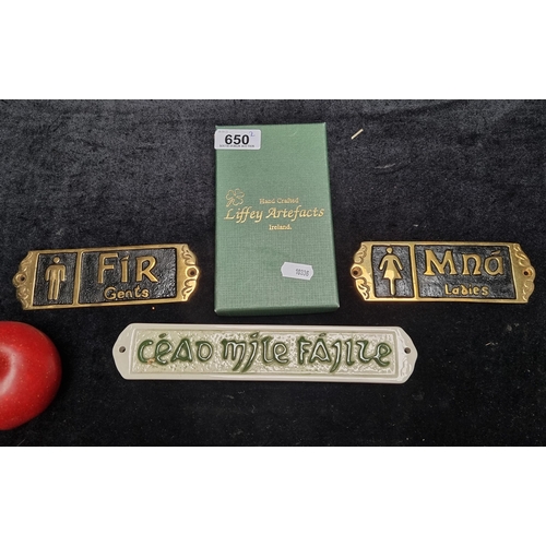 650 - Three wall mounting signs including a ceramic example reading cead mile failte and two Liffey Artefa... 