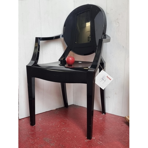 651 - A fantastic lucite Louis Ghost spoon-back open arm black chair designed by Philippe Starck for Karte... 