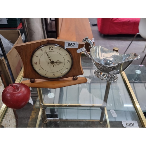 667 - Two items, including a Smith's eight day mantle clock (working) and a very heavy triple silver plate... 