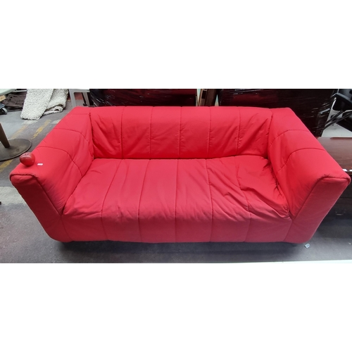 A KLIPPAN Compact two seat sofa in an off white shade with red cover. Originally from Ikea. RRP 2