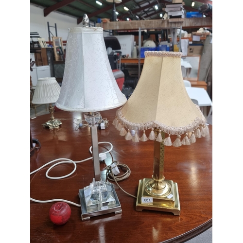 687 - Two elegant table lamps including a heavy brass Corinthian column example with peach, tasselled shad... 