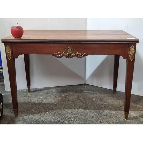 692 - A sweet coffee table with brass ormolu details and brass feet.