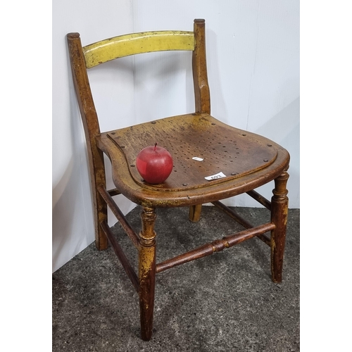 693 - An antique child's chair with pierced star seat, with brass studs.