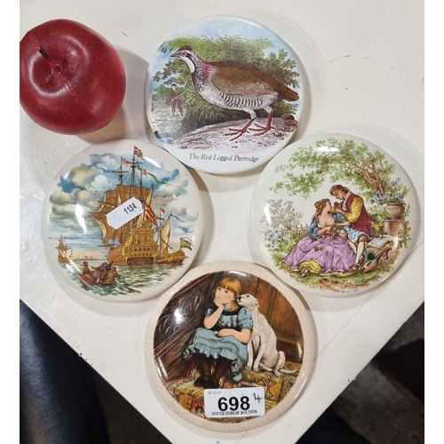 698 - Four fabulous, antique ceramic pot lids, one depicting the red-legged partridge, and another with a ... 