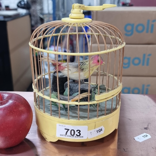 703 - A vintage probably 1980s precious battery operated, tropical singing bird in a yellow cage (untested... 