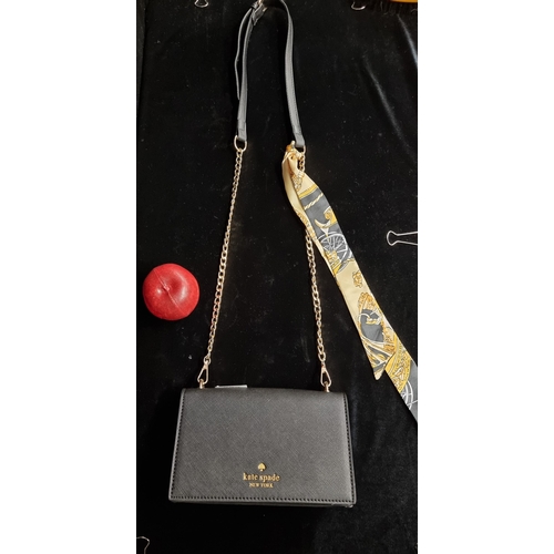 93 - A Kate Spade New York mini sling leather bag with gold toned hardware and adjustable strap. In great... 