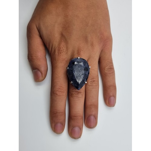 6 - A huge and extraordinary facet cut pear shaped Sapphire ring (approx 49cts), set in sterling silver.... 