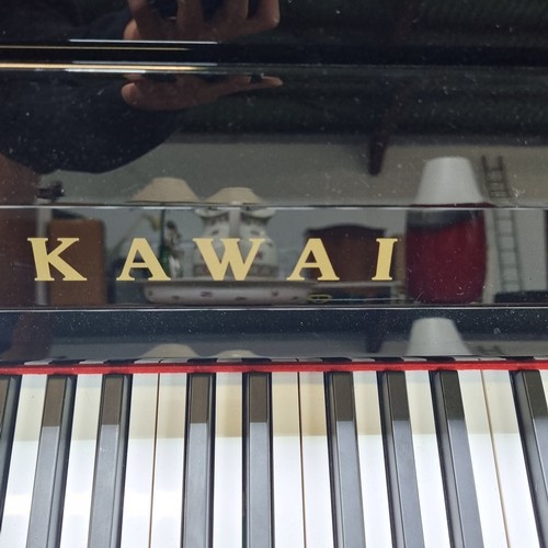 400 - Star Lot: A stunning, top quality upright piano by Kawai with a black glossy finish. Comes with orig... 