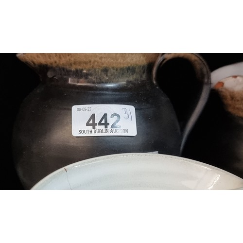 442 - A collection of 31 pieces of Stephen Pearce pottery, a striking set with matte black and mottled bro... 