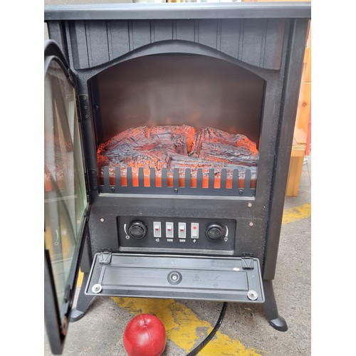 333 - A matt black, neat sized burning log effect electric heater. In good working order nice looking exam... 