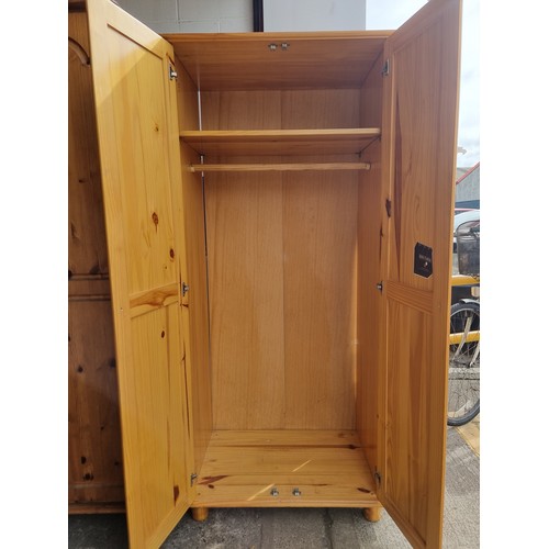 627 - Two good sized pine wood wardrobes, in clean condition.