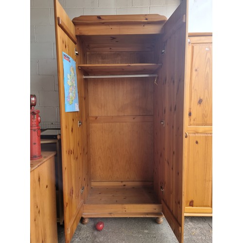 627 - Two good sized pine wood wardrobes, in clean condition.