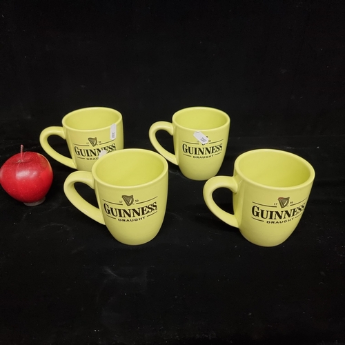 104 - A set of four Guinness branded drinking mugs, in a lime green.